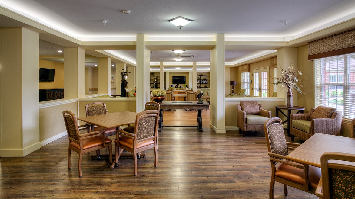 A cozy interior lounge area with comfortable seating and tables.