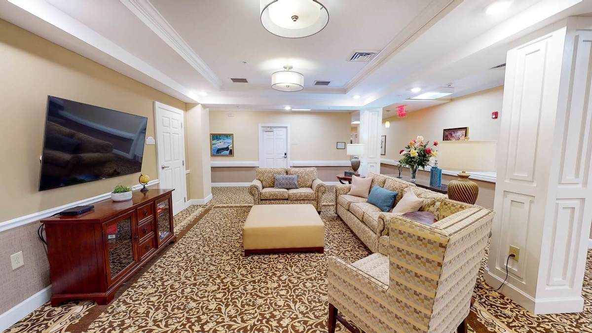 A cozy living room with comfortable sofas and warm lighting.