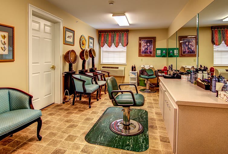 A vintage-style hair salon interior with barber chairs and mirrors.
