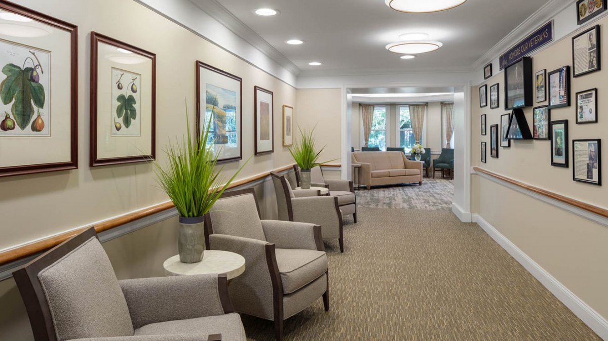 A modern lobby waiting area with comfortable chairs and decorative plants.