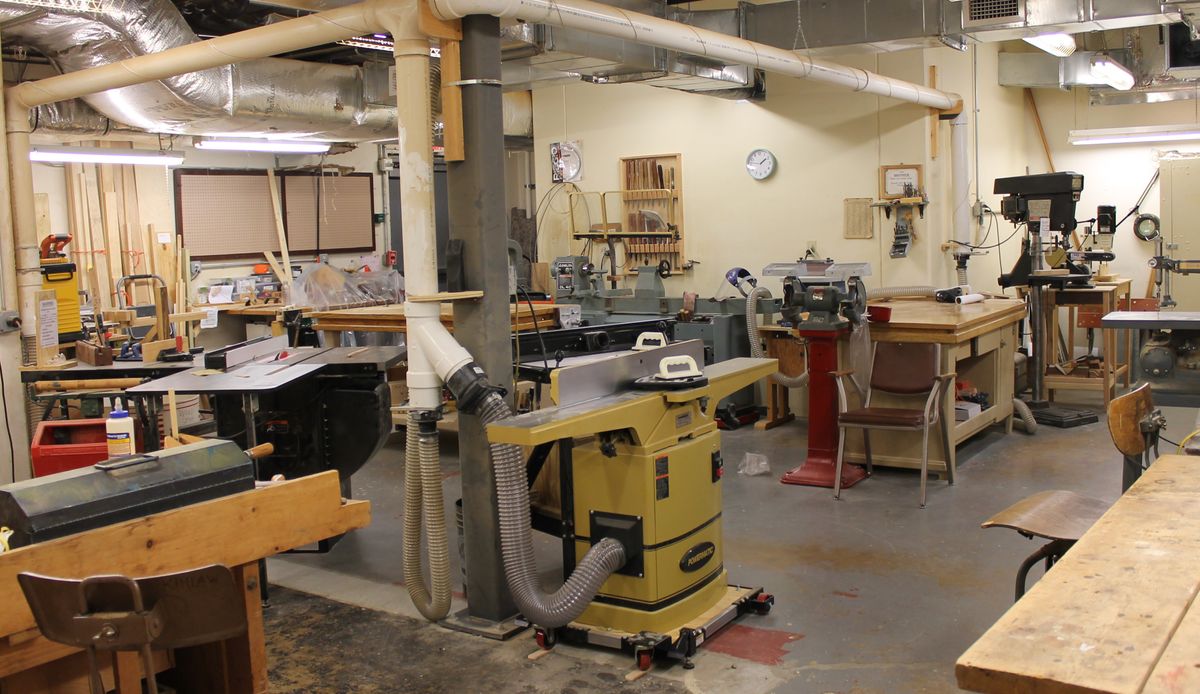 A woodworking workshop filled with various tools and machinery.