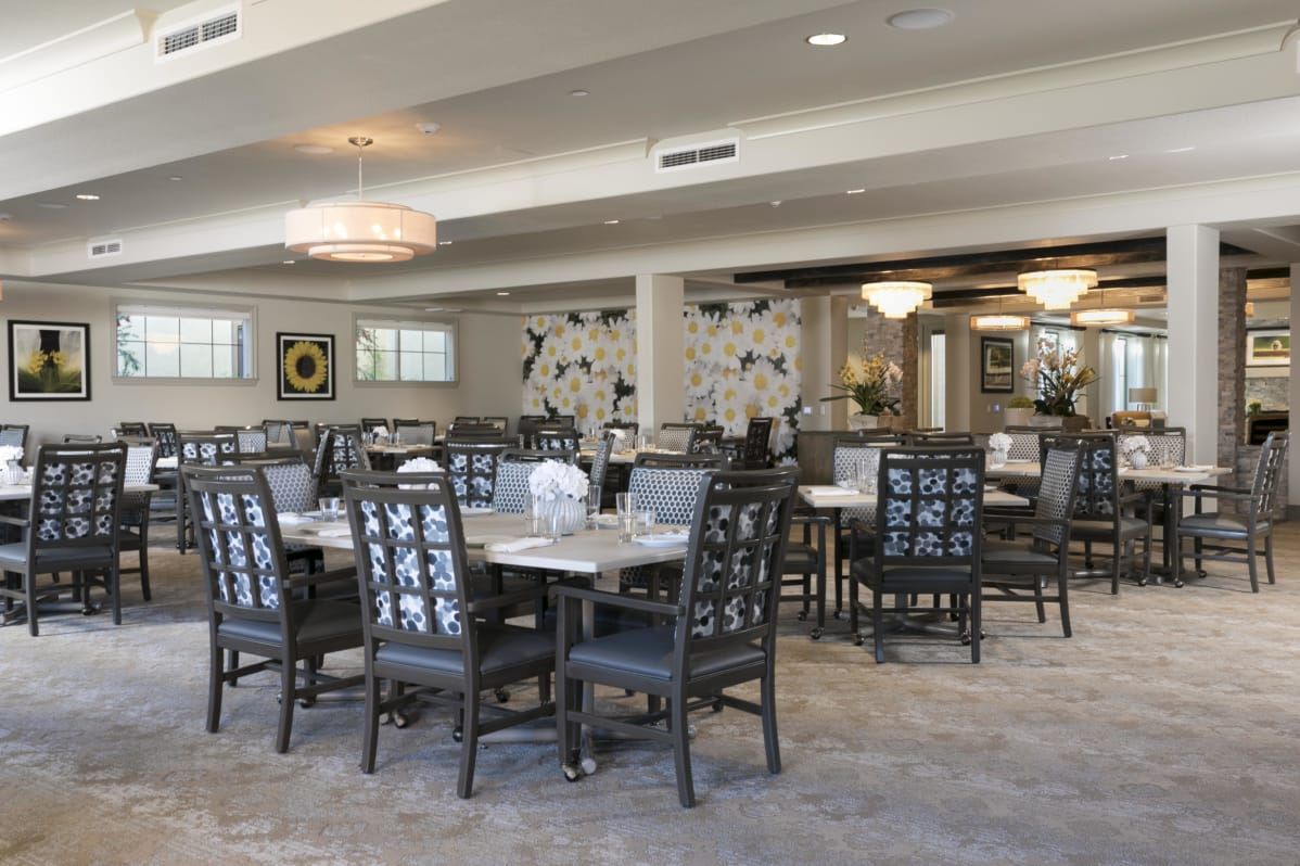 A spacious dining area with modern furnishings and elegant lighting.
