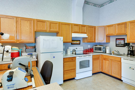 A modern kitchen featuring wooden cabinets and essential appliances.