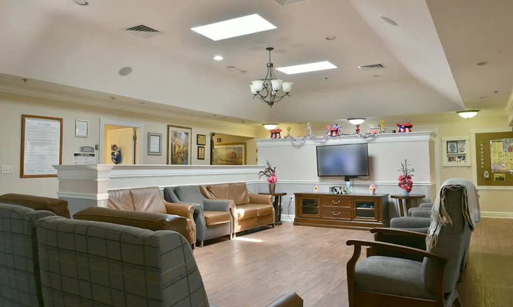 A cozy living room with comfortable seating, a television, and elegant decor.
