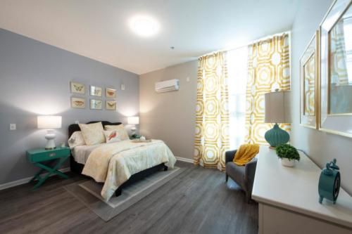 A modern and cozy bedroom with stylish decor and natural lighting.