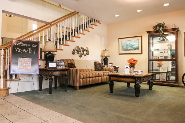 A cozy living room with a sofa, coffee table, and decorative elements near a staircase.