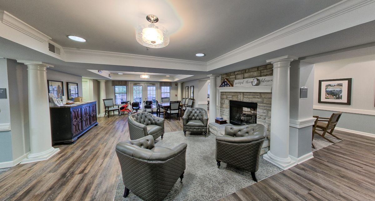 A modern living room featuring a comfortable seating area with a fireplace and elegant interior design.