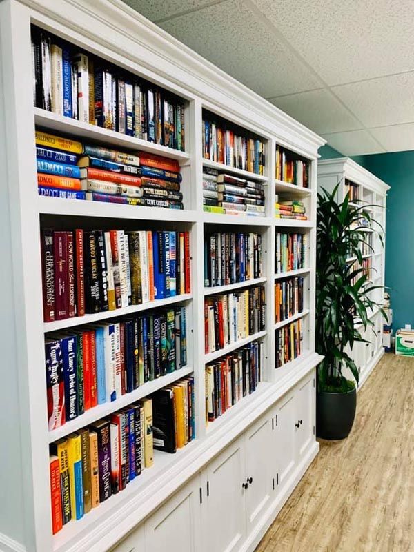 A cozy reading area with well-stocked bookshelves.