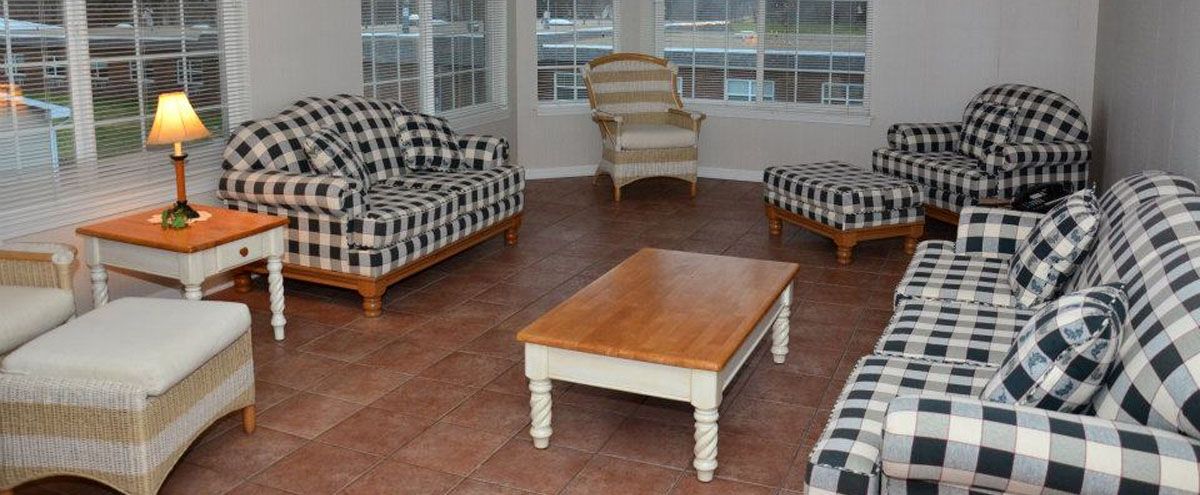 A cozy living room with checkered sofas and a wooden coffee table.
