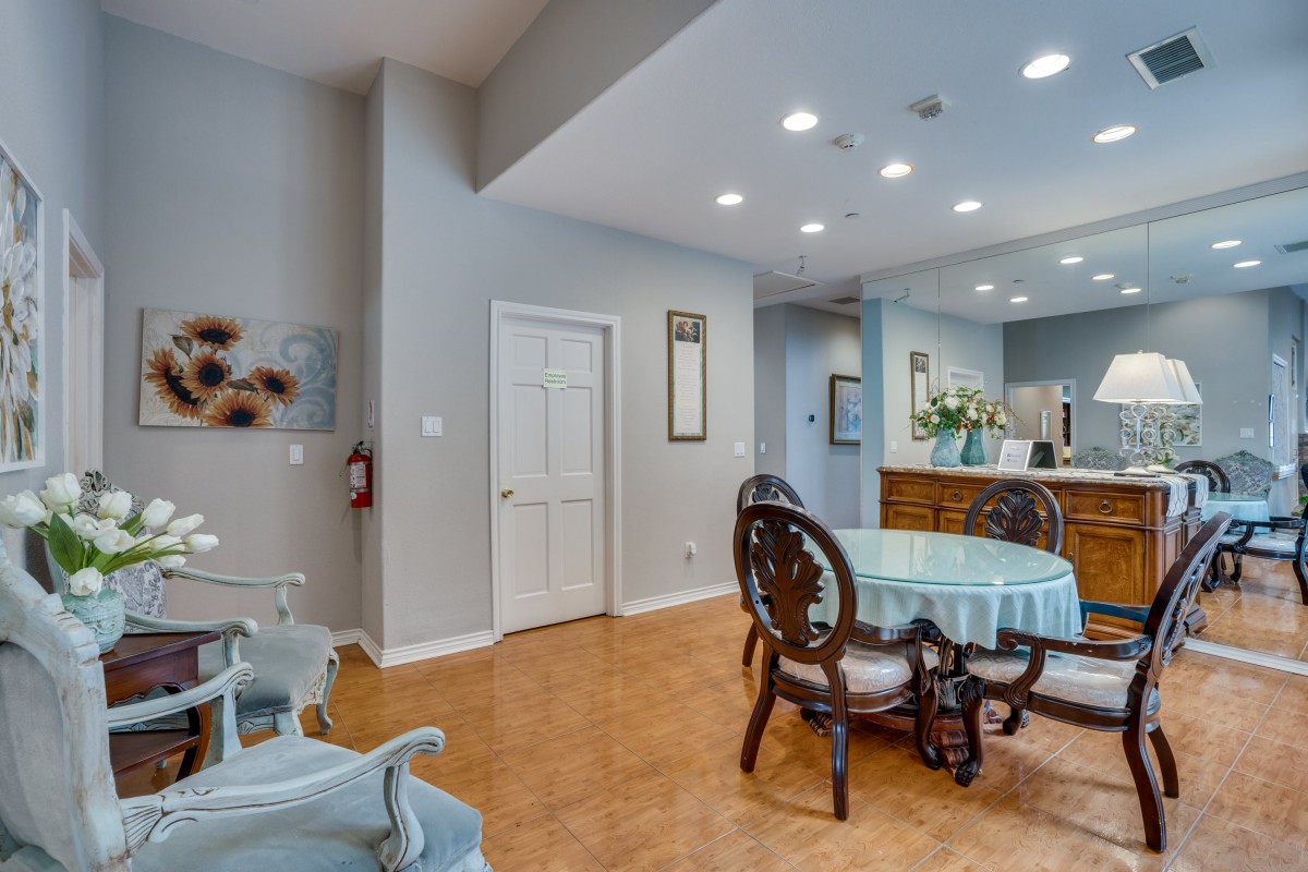 A cozy dining area with a round table and chairs adjacent to a kitchen space.