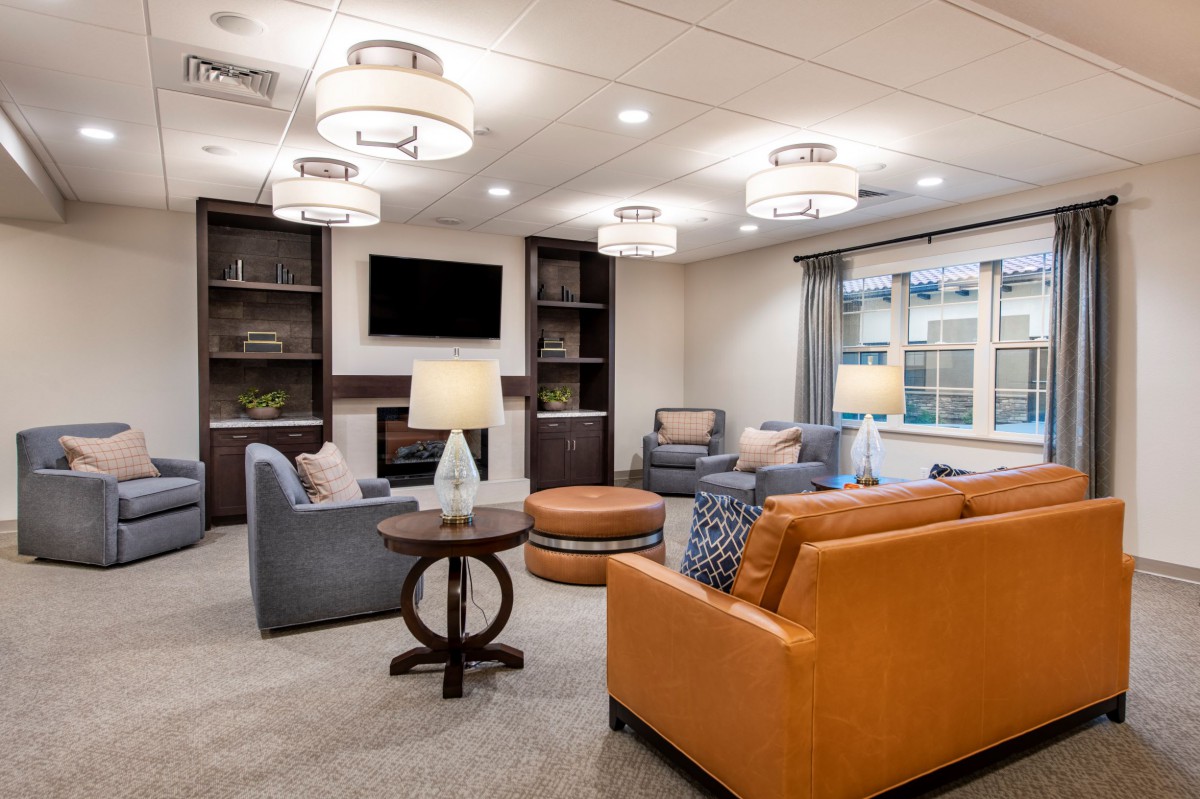 A modern living room with comfortable seating and stylish lighting fixtures.