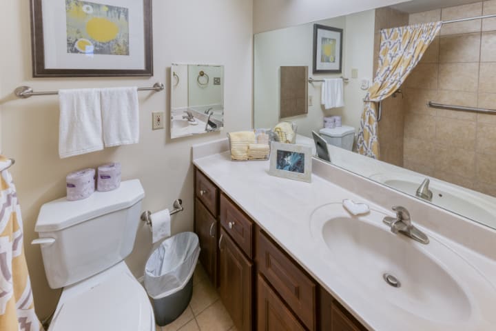 A well-organized bathroom with a sink, mirror, and vanity.