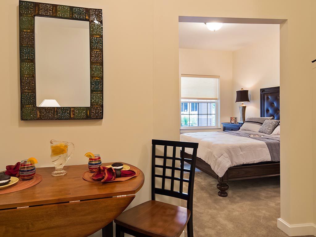 A cozy bedroom view with a small table and stylish decor.