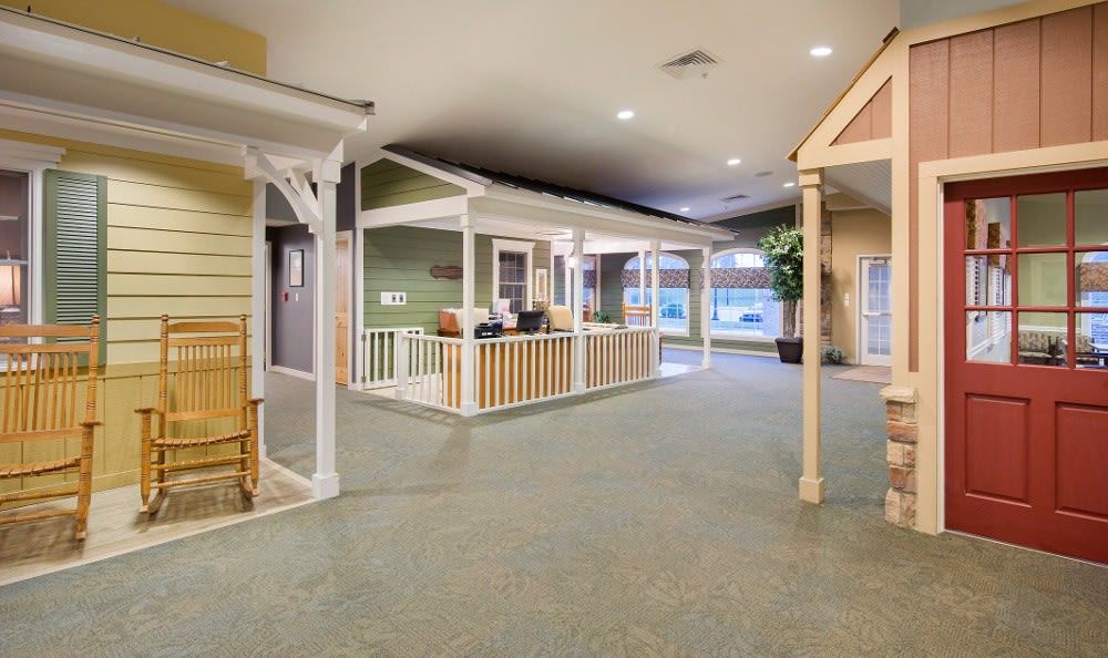 A well-lit, carpeted reception area with decorative columns and a welcoming desk.