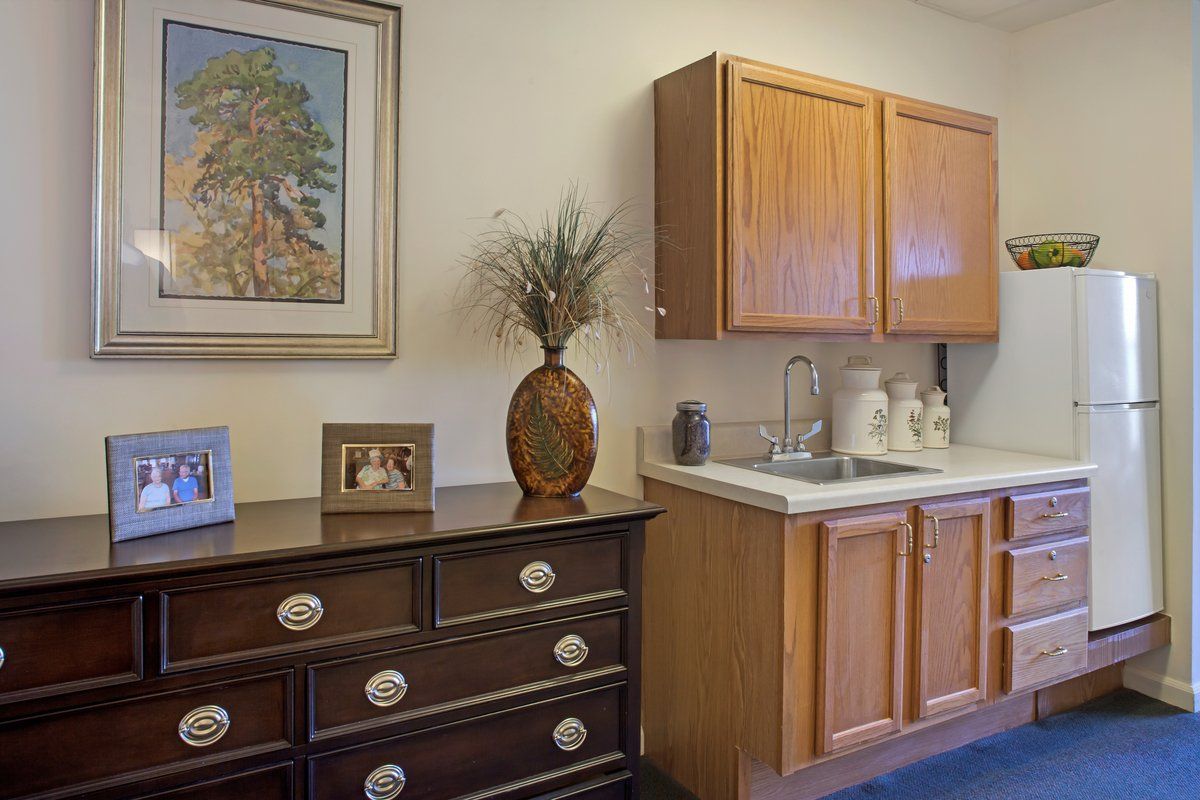 A small kitchenette area with wooden cabinets and decorative elements.
