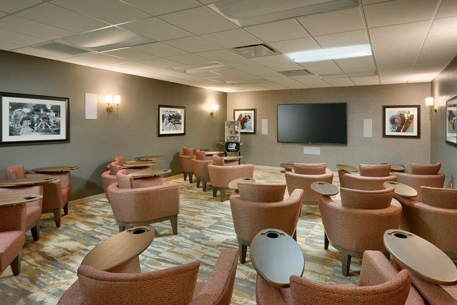 A well-appointed conference room with comfortable seating and a large television screen for presentations.