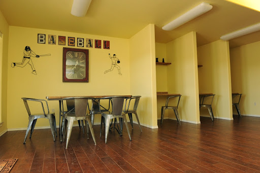 A cozy dining area featuring yellow walls and stylish metal chairs, perfect for casual gatherings.