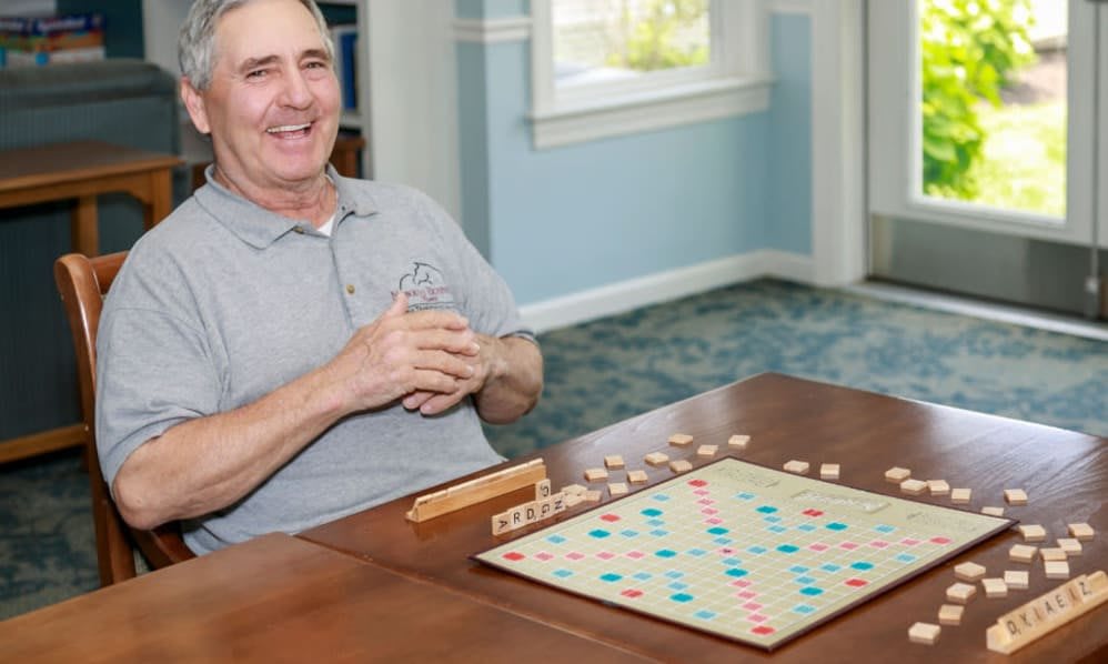 A man enjoying a game of Scrabble indoors.
