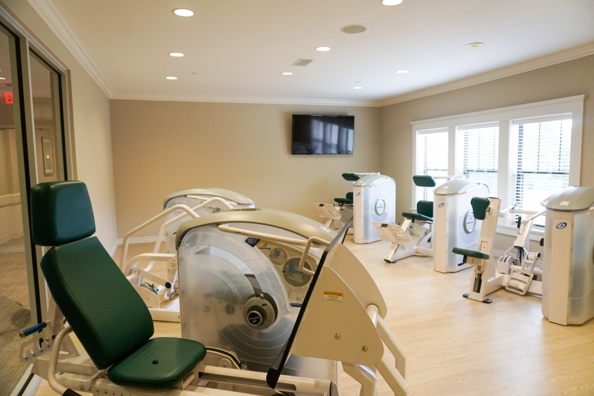 A well-lit fitness center featuring various exercise machines.