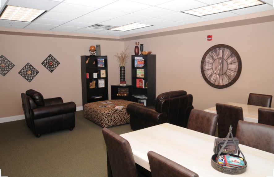 A cozy office meeting room with comfortable seating and decorative elements.