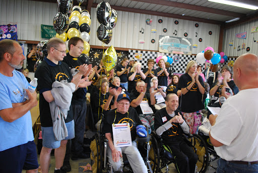 A joyful gathering celebrating community spirit with participants clapping and enjoying the festivities.