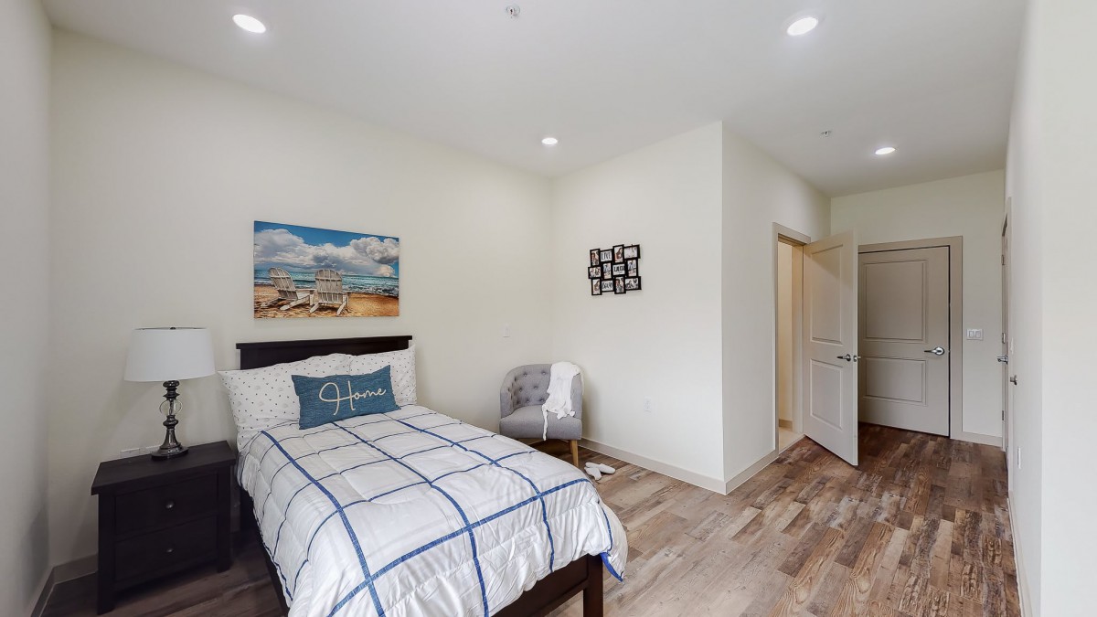 A modern, minimalist bedroom with a neatly made bed and stylish decor.