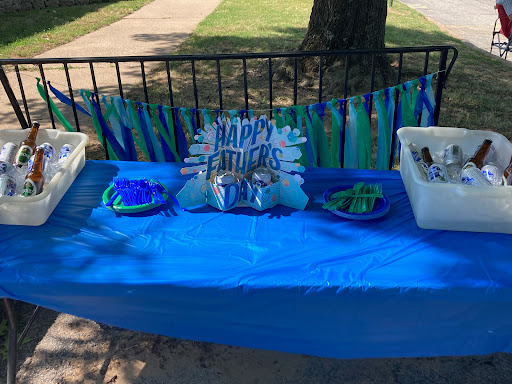 A vibrant blue-themed buffet table set up for an outdoor celebration.