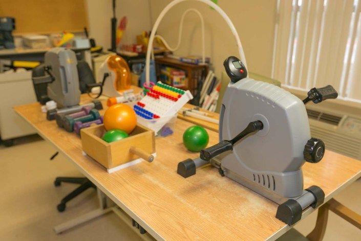 A workshop desk with various tools and equipment, including colorful balls and electronic devices.