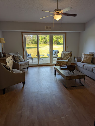 A cozy living room with comfortable seating and a view of the outdoors.
