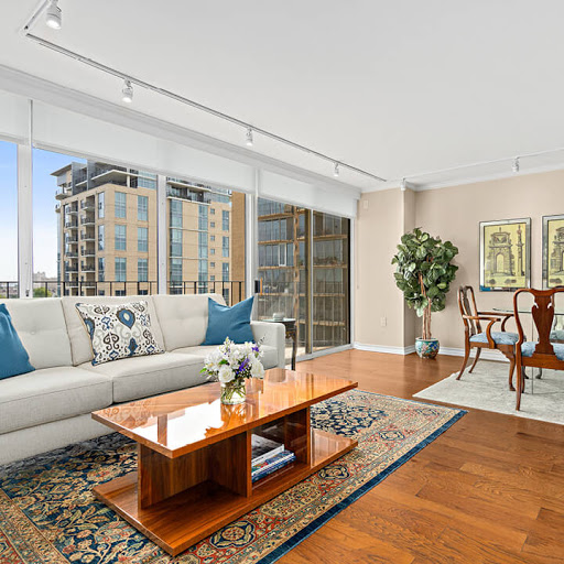 A bright and modern living room featuring elegant furniture and a stunning city view.
