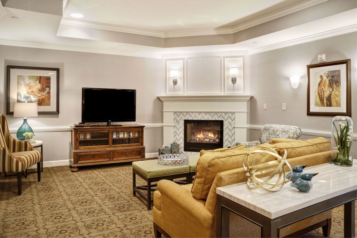 A cozy living room with a fireplace, TV, and comfortable seating.