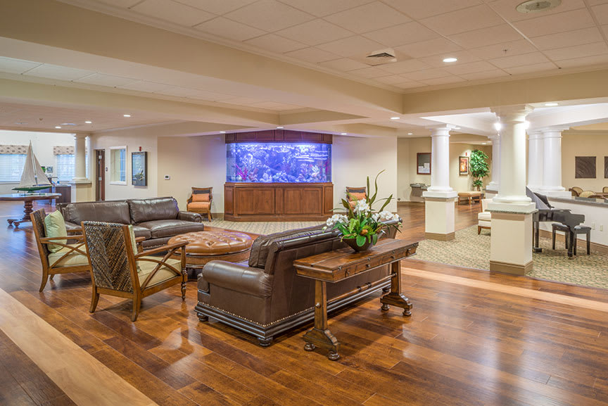 A welcoming lobby area featuring comfortable seating, a large aquarium, and elegant decor.