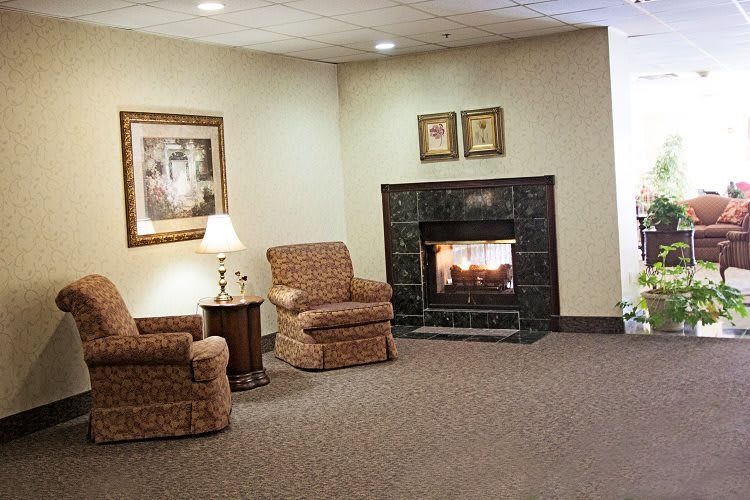 Cozy seating area with armchairs and a fireplace.