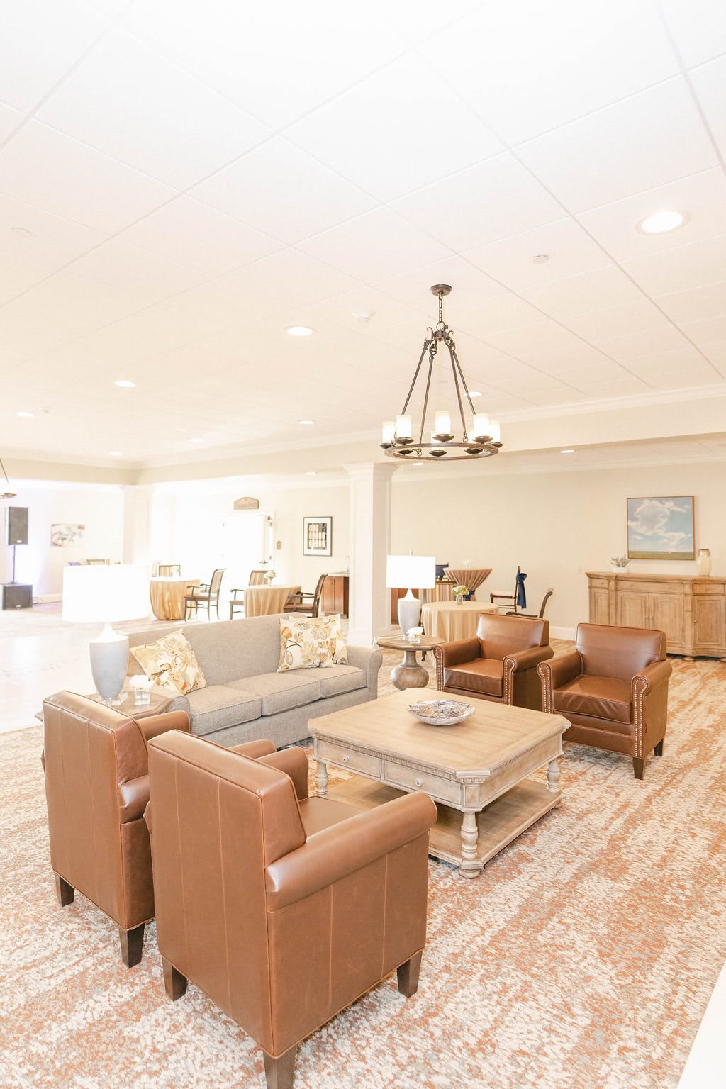 A spacious and elegantly designed living room featuring comfortable seating and modern decor.