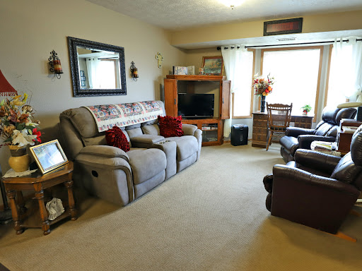 A cozy living room featuring comfortable seating and warm decor.