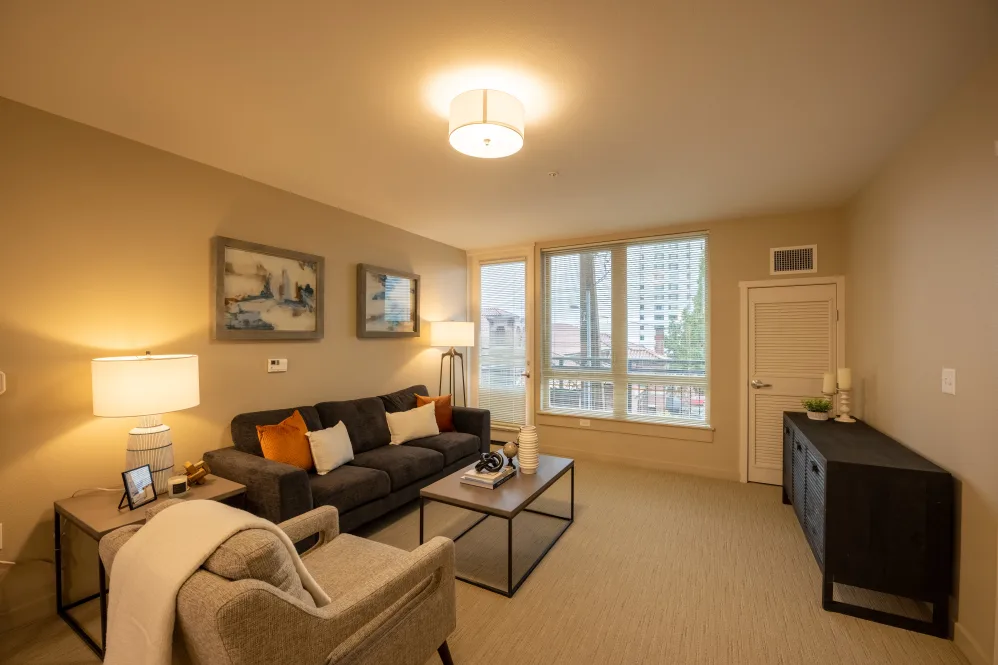 A cozy living room with a comfortable sofa, coffee table, and artistic decor.