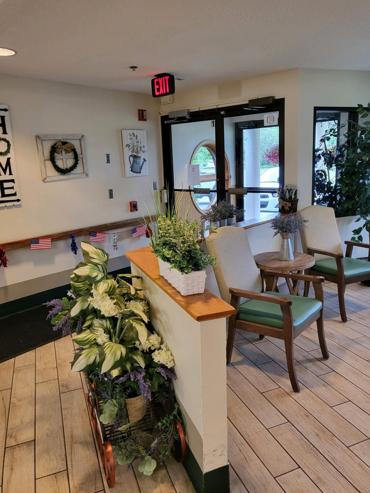 A cozy lobby area with plants, chairs, and welcoming decor near the entrance.
