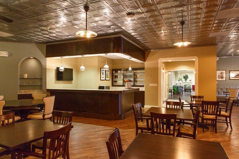 An empty restaurant interior with a bar and seating area.