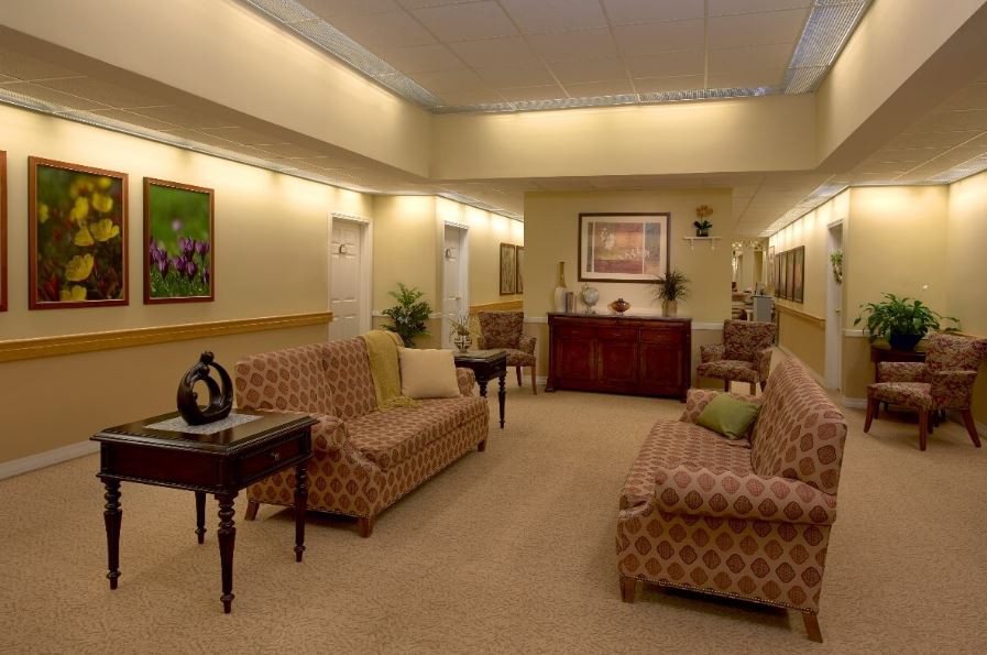 A well-lit waiting room with comfortable seating and elegant decor.