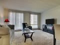 A modern living room with a comfortable sofa, coffee table, and large television setup.