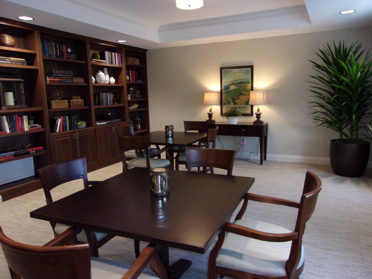 A quiet study room with bookshelves, tables, and chairs for reading.