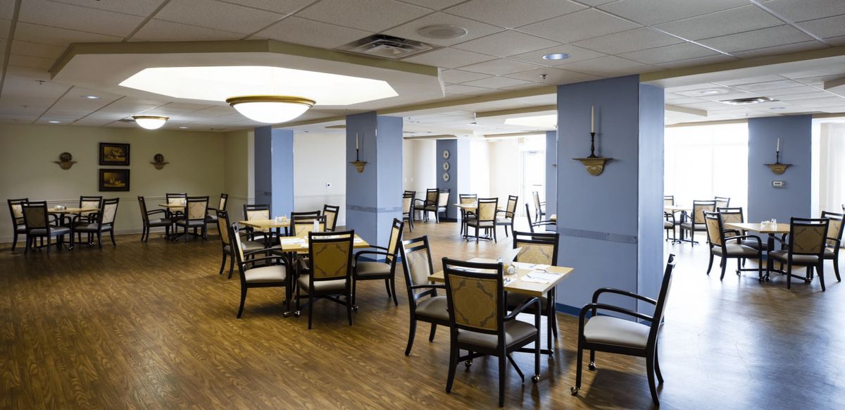 A spacious dining area with neatly arranged tables and chairs.