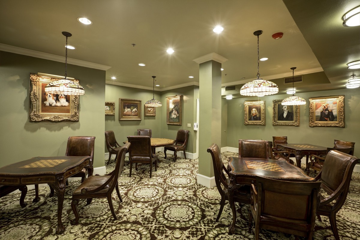 A stylish lounge area with elegant tables, chairs, and classic decor.