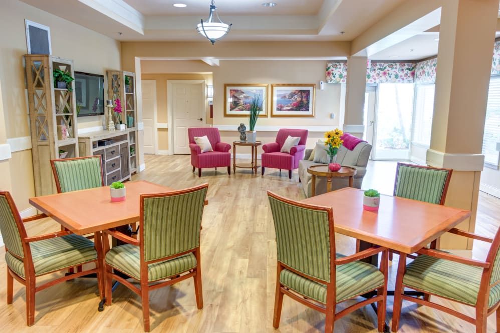 A cozy and well-lit living area with comfortable seating and dining tables.