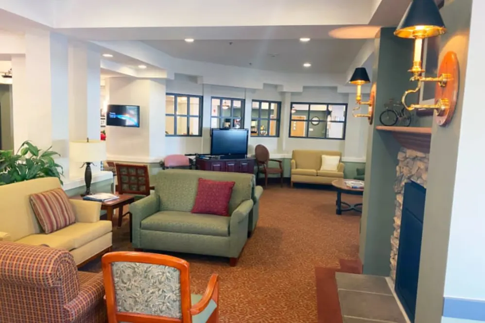 A cozy living room with multiple seating options and a television.