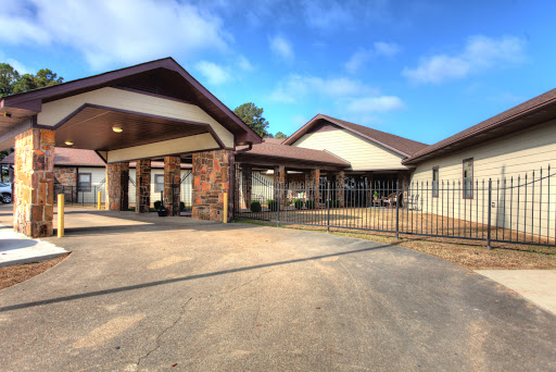 A charming residence featuring a gated entrance and a welcoming facade under clear blue skies.