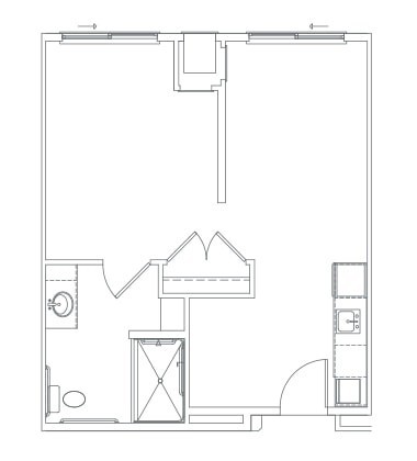 A simple floor plan depicting a single-room apartment with a bathroom and small kitchen area.