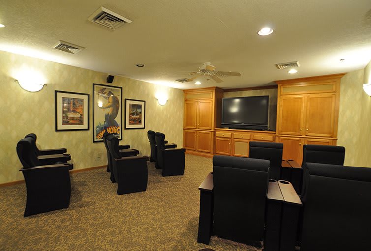 A cozy home theater with comfortable seating and a large screen.