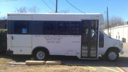 A side view of a white bus parked, likely used for public transportation.