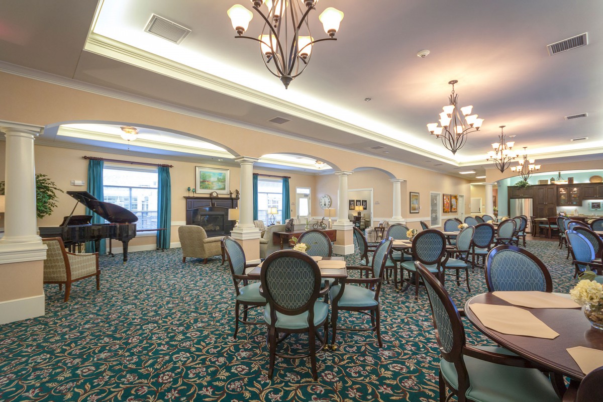 An elegant dining room with stylish furnishings and chandeliers.
